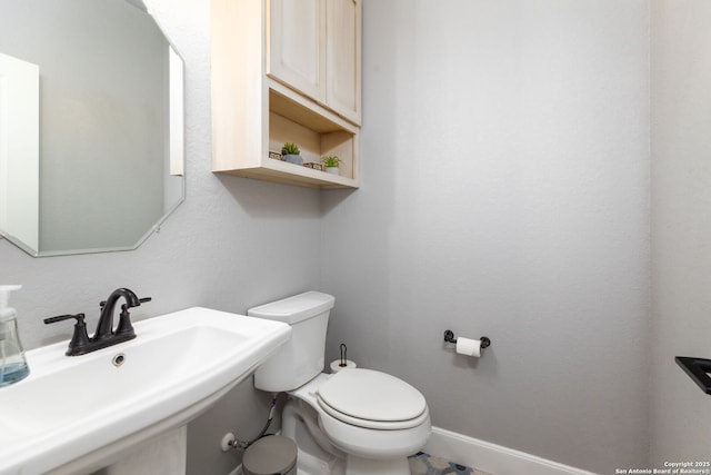 bathroom with toilet and sink