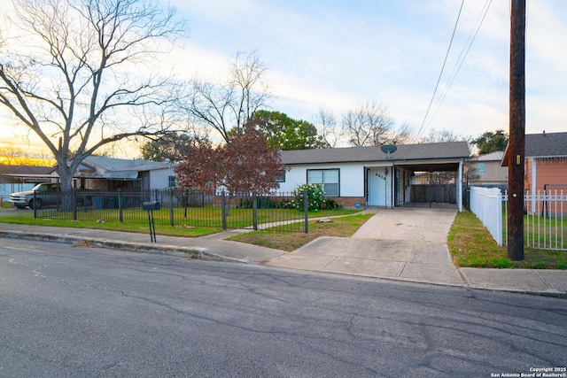 ranch-style house with a carport and a lawn