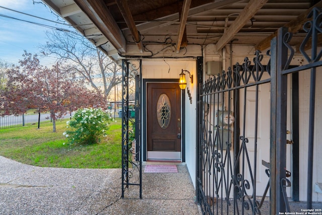 entrance to property featuring a yard