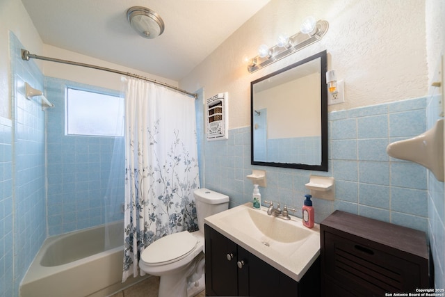 full bathroom featuring tile walls, toilet, shower / tub combo with curtain, and vanity