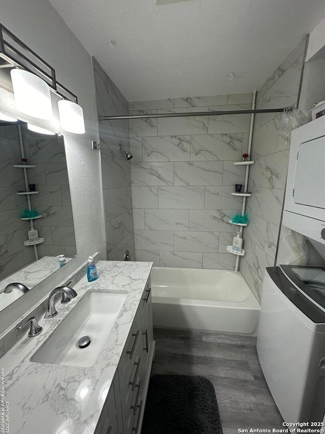 bathroom featuring tiled shower / bath combo, vanity, and wood-type flooring