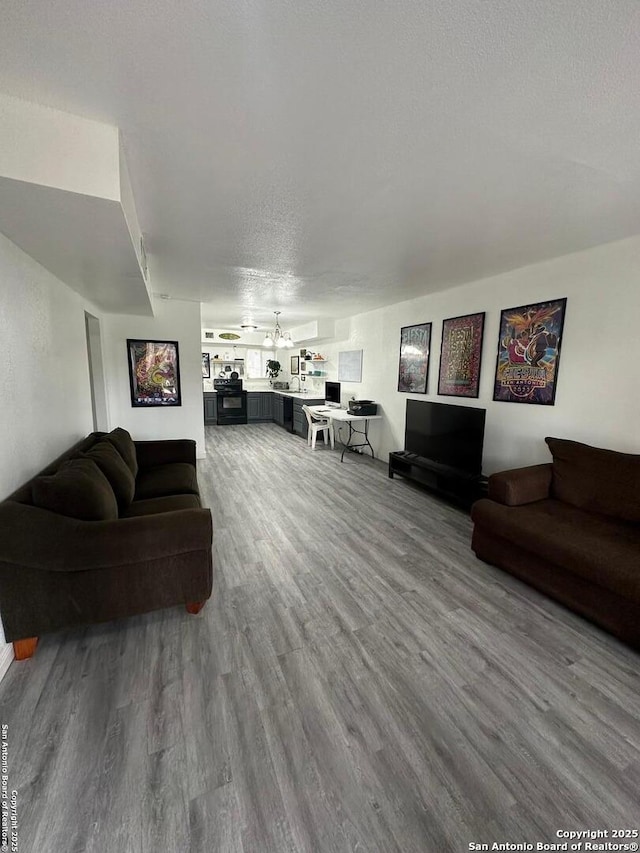 living room featuring a textured ceiling and hardwood / wood-style floors