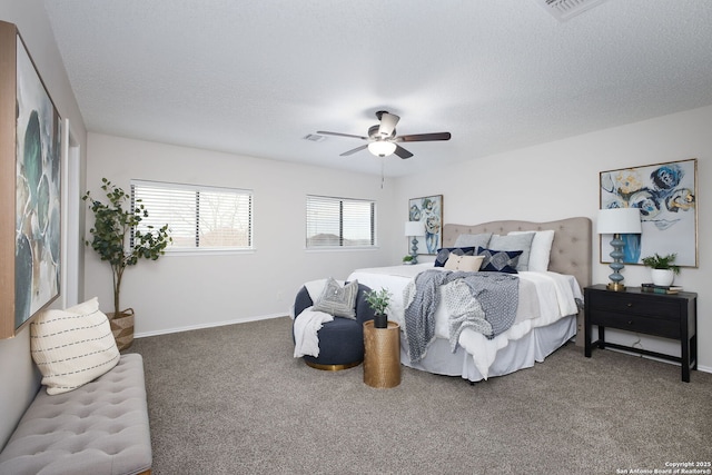 carpeted bedroom with a textured ceiling and ceiling fan