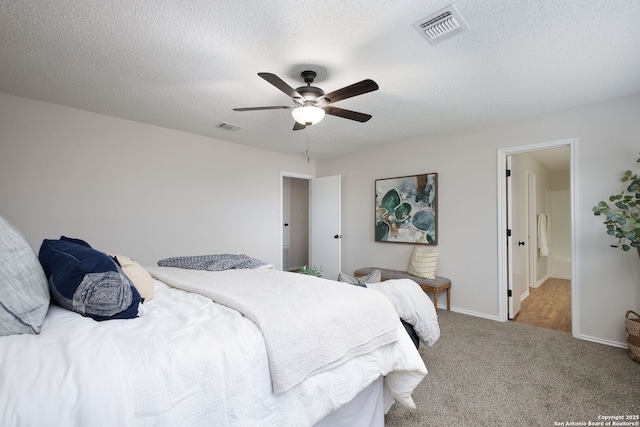 carpeted bedroom with a textured ceiling and ceiling fan