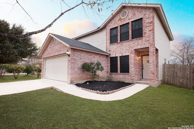 view of front of property with a garage and a lawn