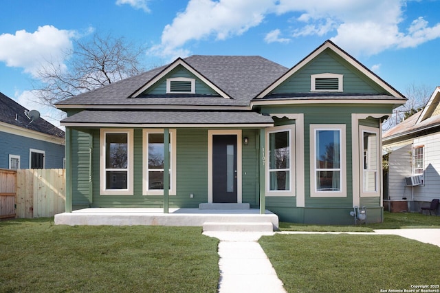 bungalow-style home featuring a porch, cooling unit, and a front yard