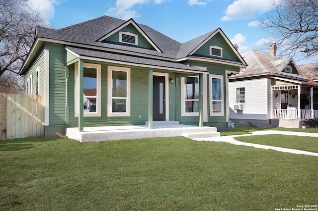 bungalow with a front yard, a porch, and cooling unit