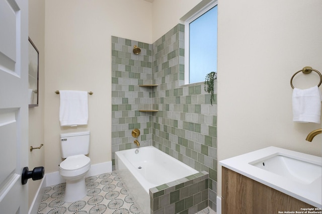 full bathroom with toilet, vanity, and tiled shower / bath