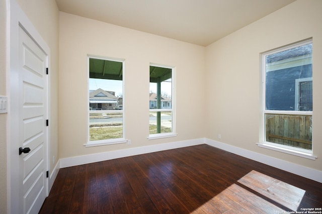 spare room with dark wood-type flooring