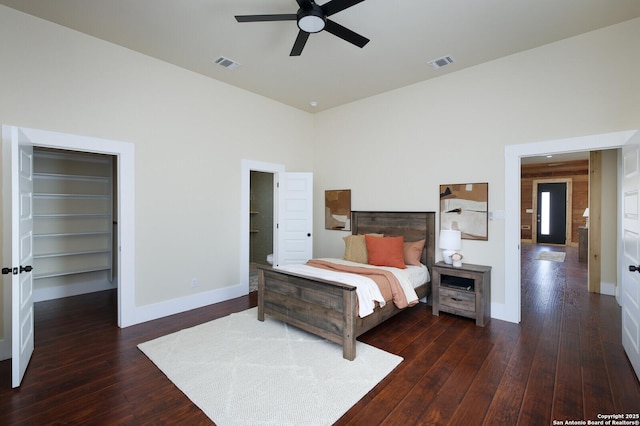 bedroom with a closet, ceiling fan, and dark wood-type flooring