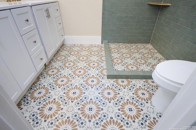 bathroom featuring toilet, tile patterned floors, and vanity