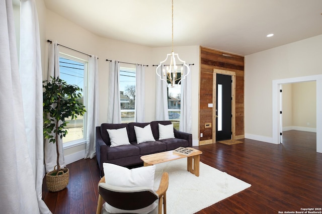 living room featuring an inviting chandelier and dark hardwood / wood-style floors