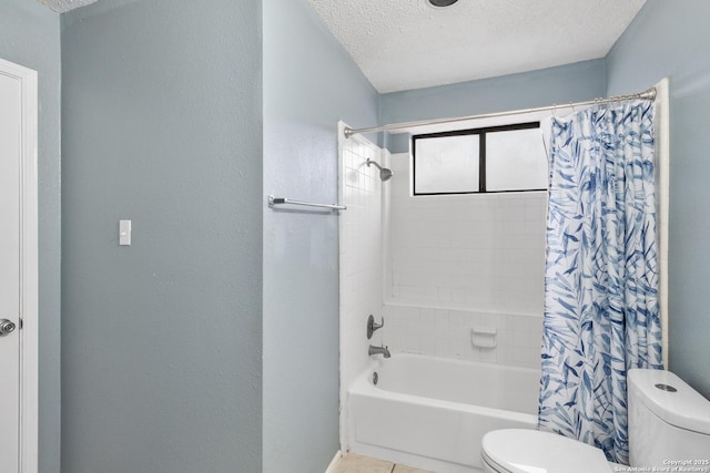 bathroom with a textured ceiling, shower / bath combination with curtain, tile patterned flooring, and toilet