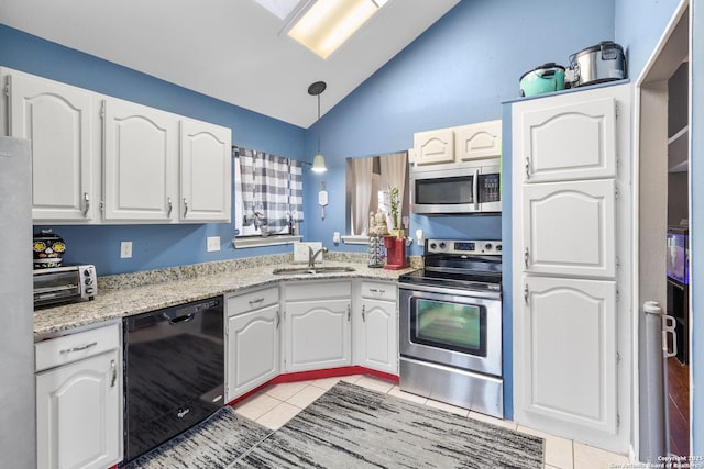 kitchen featuring sink, decorative light fixtures, white cabinetry, vaulted ceiling, and appliances with stainless steel finishes