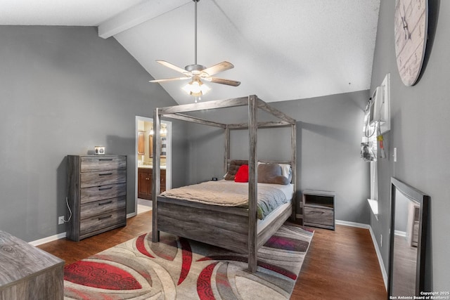 bedroom with ceiling fan, lofted ceiling with beams, ensuite bath, and dark hardwood / wood-style floors