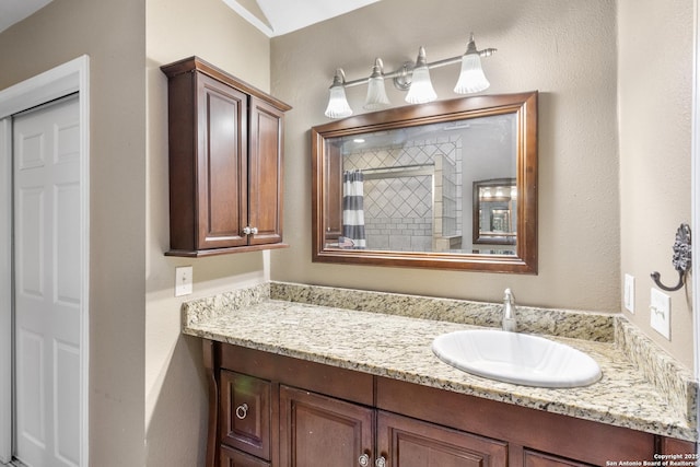 bathroom featuring vanity and a shower with curtain