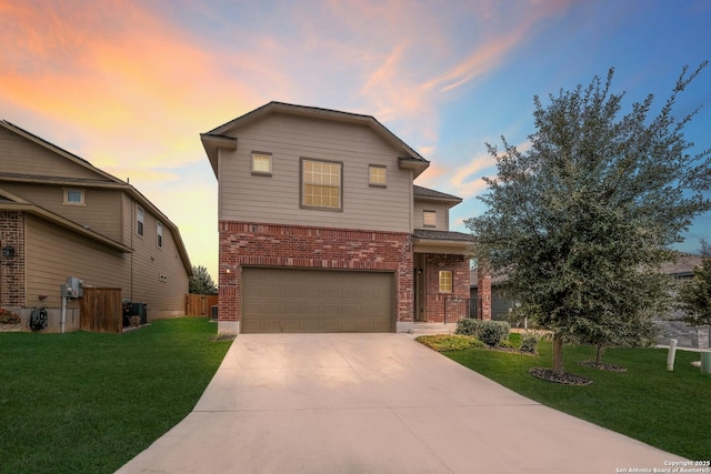 front of property with a garage and a yard