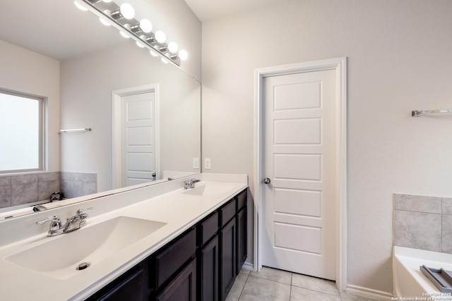 bathroom with a bathing tub, tile patterned flooring, and vanity