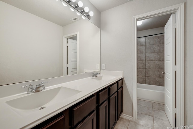 bathroom featuring vanity, tile patterned floors, and tiled shower / bath