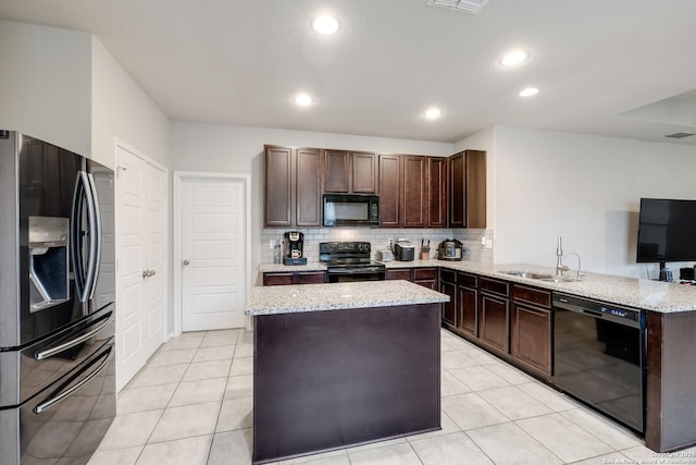 kitchen featuring black appliances, kitchen peninsula, dark brown cabinetry, sink, and backsplash