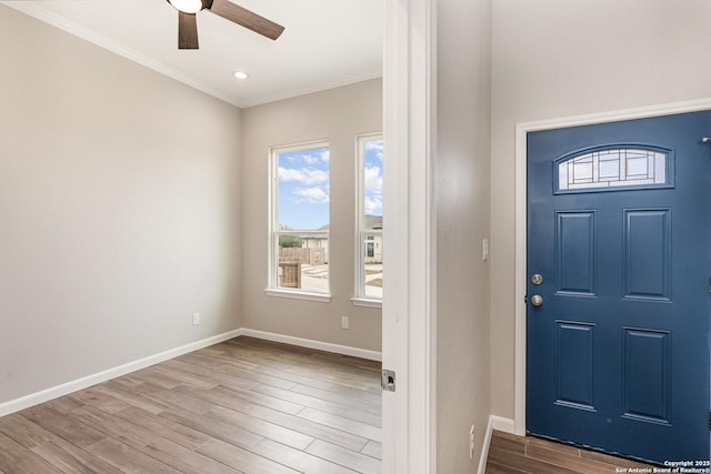 entryway featuring crown molding, ceiling fan, and light hardwood / wood-style flooring