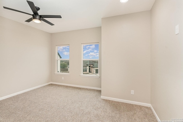 spare room with ceiling fan and carpet