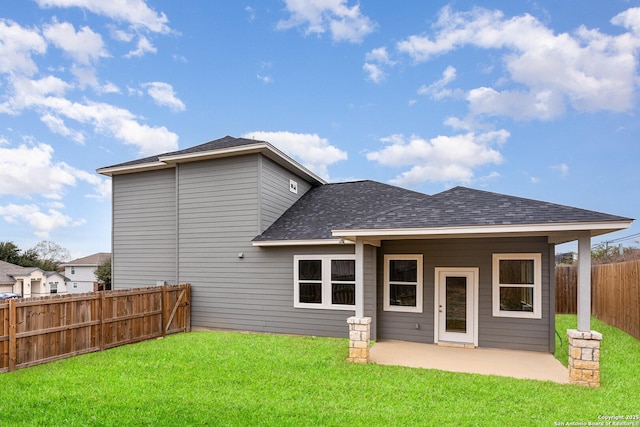 rear view of house with a yard and a patio