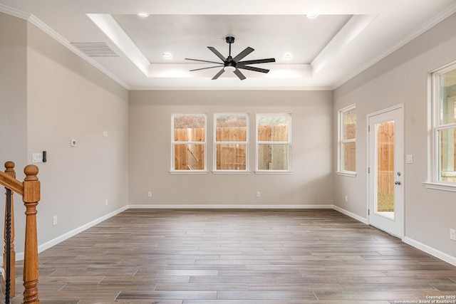 spare room featuring ornamental molding, a raised ceiling, ceiling fan, and wood-type flooring