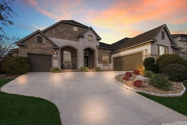 french provincial home with a garage