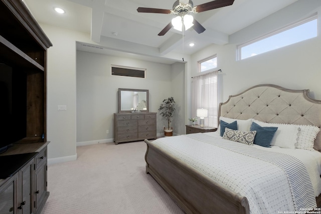 carpeted bedroom featuring beamed ceiling and ceiling fan