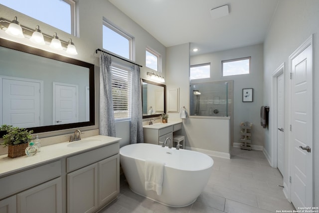 bathroom featuring vanity, tile patterned flooring, and separate shower and tub