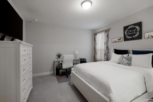 carpeted bedroom featuring a textured ceiling