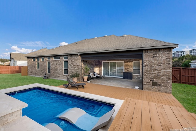 view of pool with a yard and a patio area