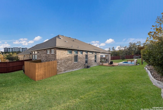 back of house with a patio and a lawn