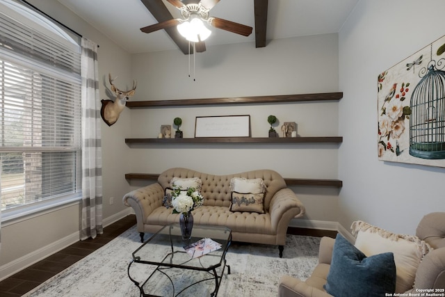 living room featuring beamed ceiling, dark hardwood / wood-style floors, and ceiling fan