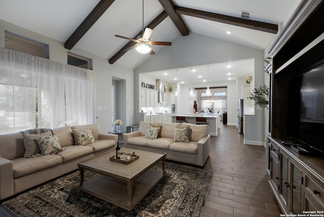 living room with dark hardwood / wood-style floors, ceiling fan, beam ceiling, and high vaulted ceiling