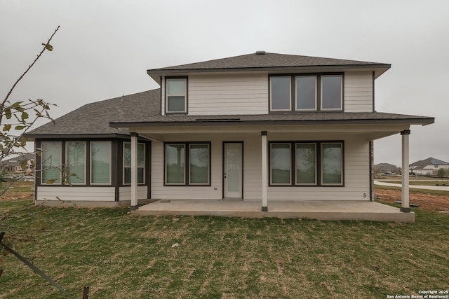 9314 Everly Crk, San Antonio, TX 78263 - back of house featuring a shingled roof, a yard, and a patio area