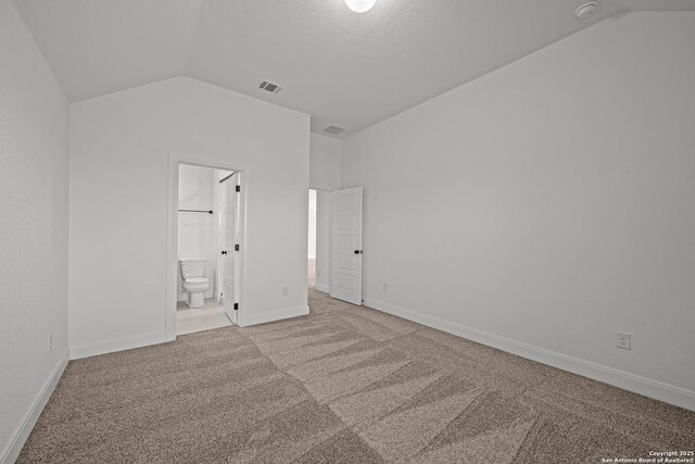 9314 Everly Crk, San Antonio, TX 78263 - unfurnished bedroom featuring vaulted ceiling, carpet flooring, baseboards, connected bathroom, and visible vents