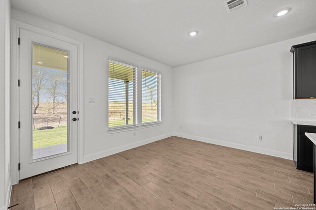 9314 Everly Crk, San Antonio, TX 78263 - unfurnished living room with light wood-style flooring, recessed lighting, baseboards, and visible vents