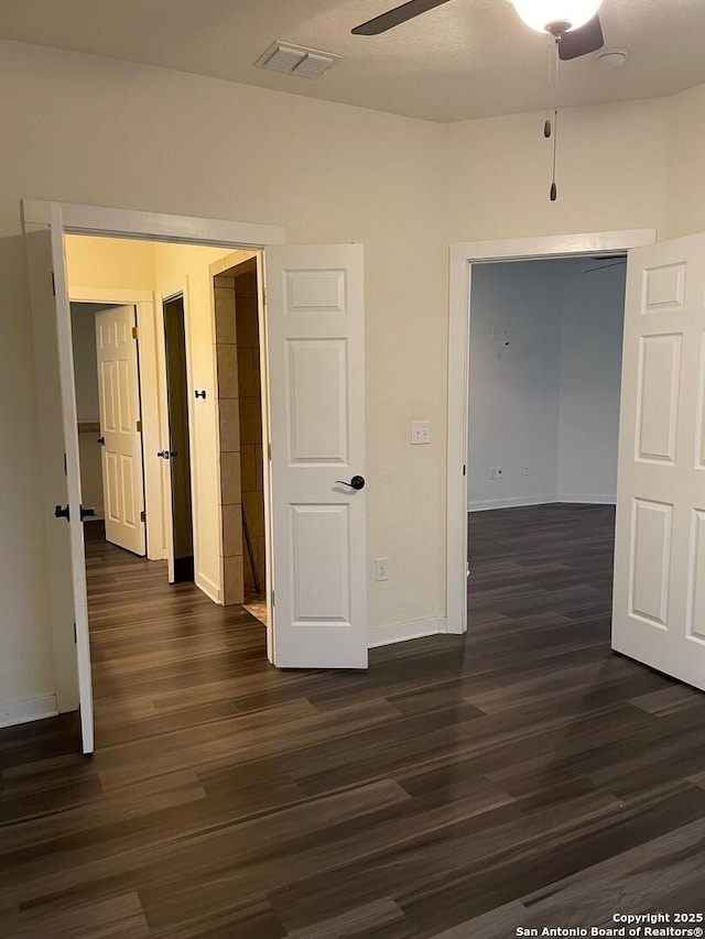 spare room featuring ceiling fan and dark hardwood / wood-style floors