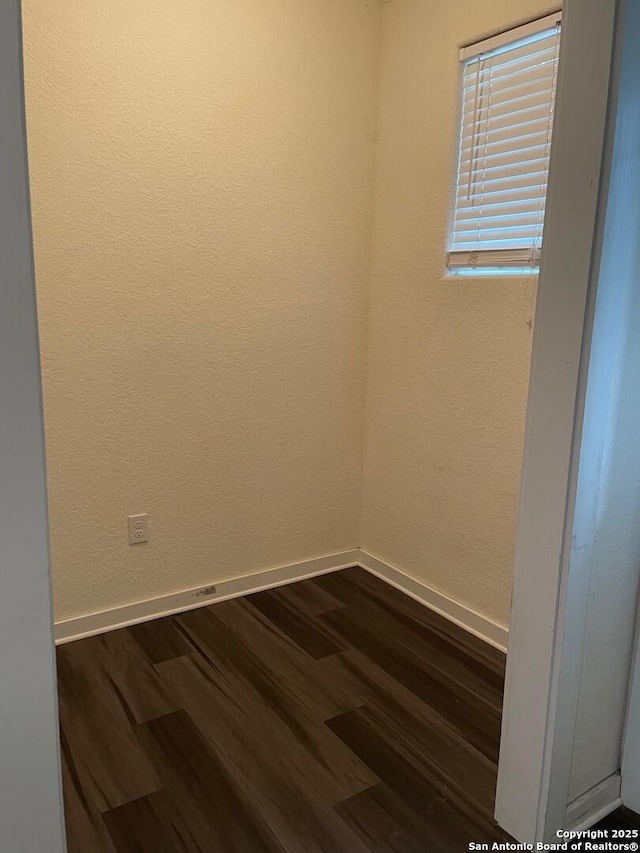 spare room with dark hardwood / wood-style floors