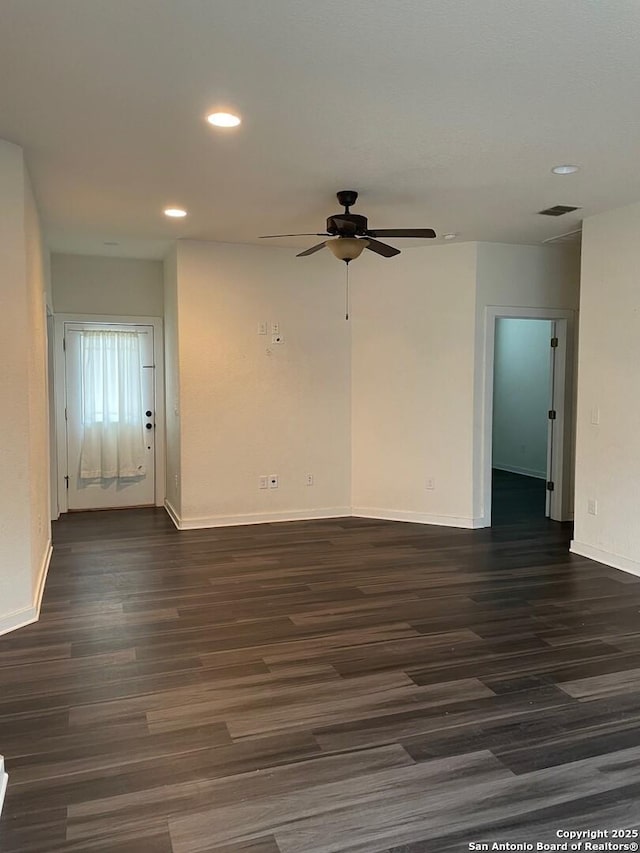 empty room featuring ceiling fan and dark hardwood / wood-style floors