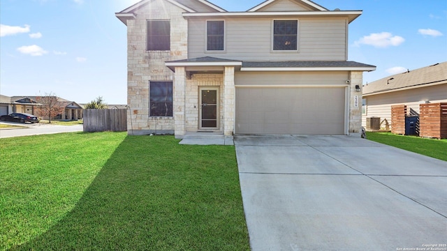 view of property featuring a front yard and a garage