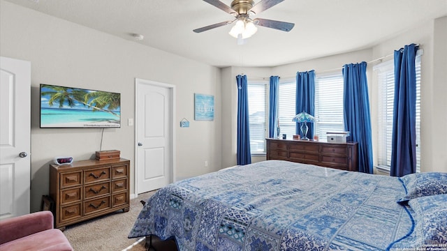 bedroom featuring light carpet and ceiling fan