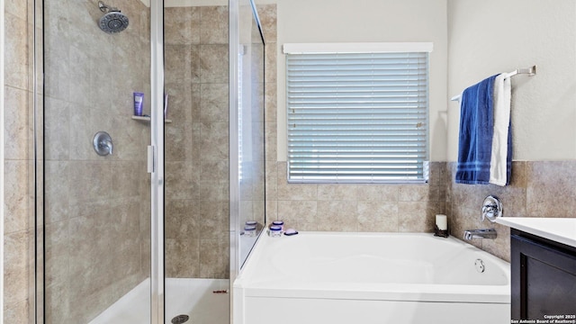 bathroom featuring independent shower and bath and vanity