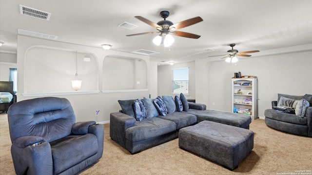 carpeted living room with ceiling fan