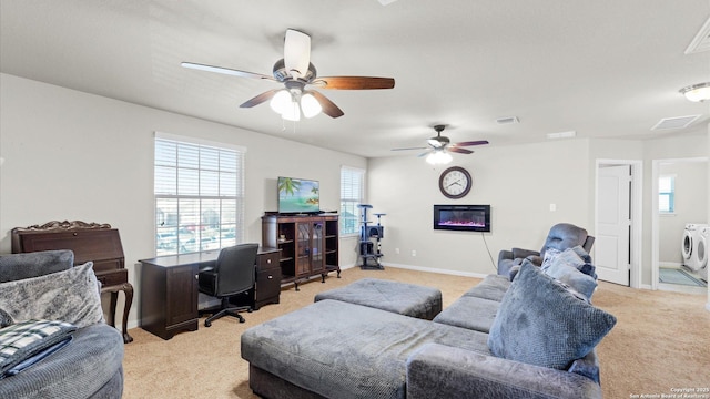 carpeted living room featuring ceiling fan and washer and clothes dryer