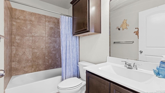 full bathroom featuring toilet, shower / bath combo with shower curtain, and vanity