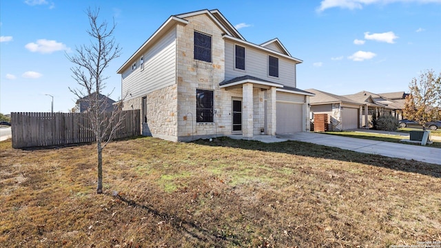 front of property with a front yard and a garage