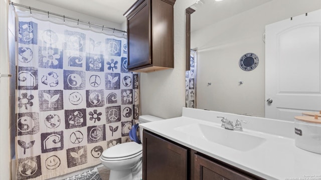 bathroom with toilet and vanity